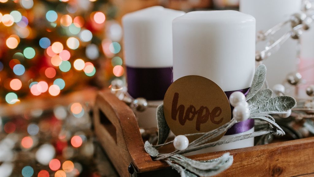 Two gift candles in a box with a gift tag with the word Hope written on it.