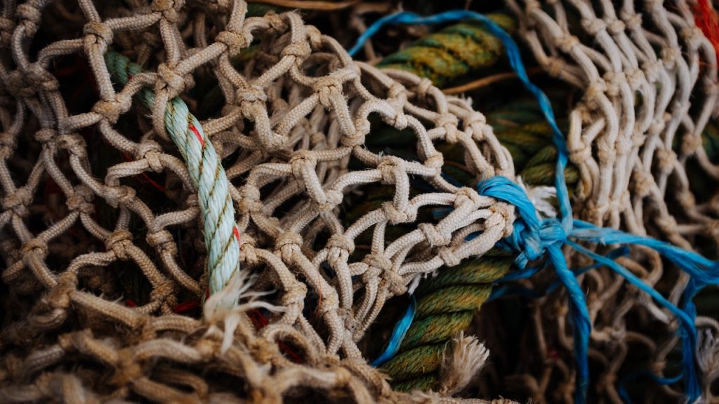 A jumble of fishing nets and ropes of different sizes.