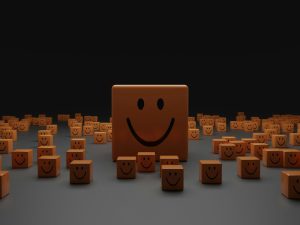 Many cubes with smiley faces all sitting on the floor and looking at the camera!