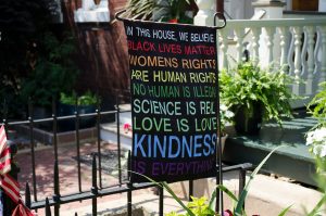 A banner with the words: In this house black lives matter, womens rights are human rights, no human is illegal, science is real, love is love, kindness is everything.