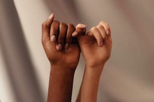 Two hands connect pinkies or little fingers in a way that says, "I promise."