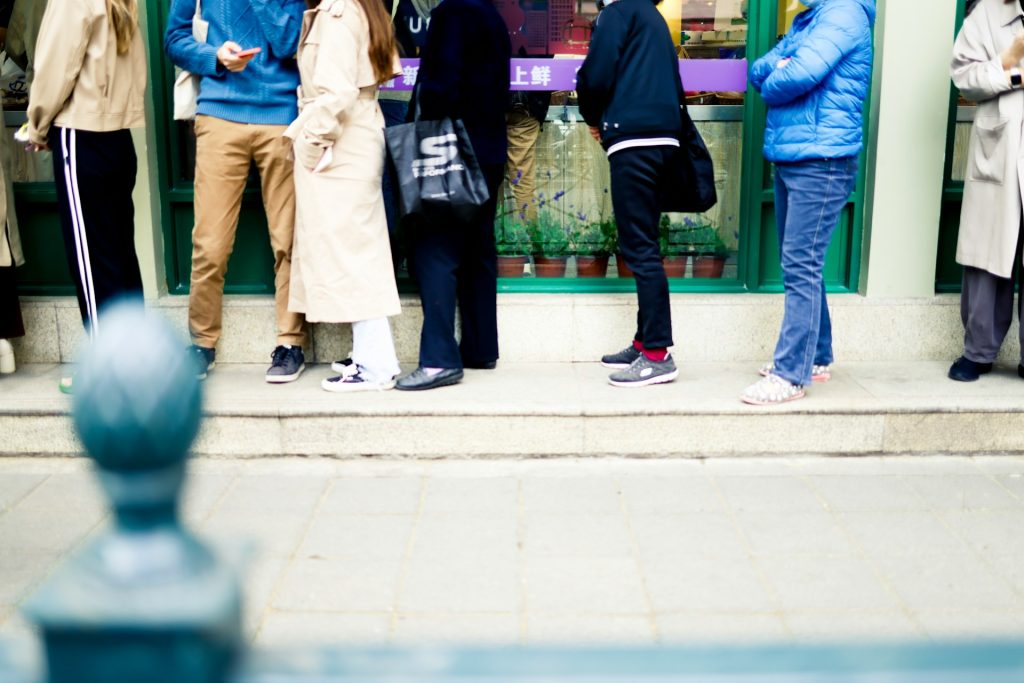 A line of all sorts of different people queuing up.