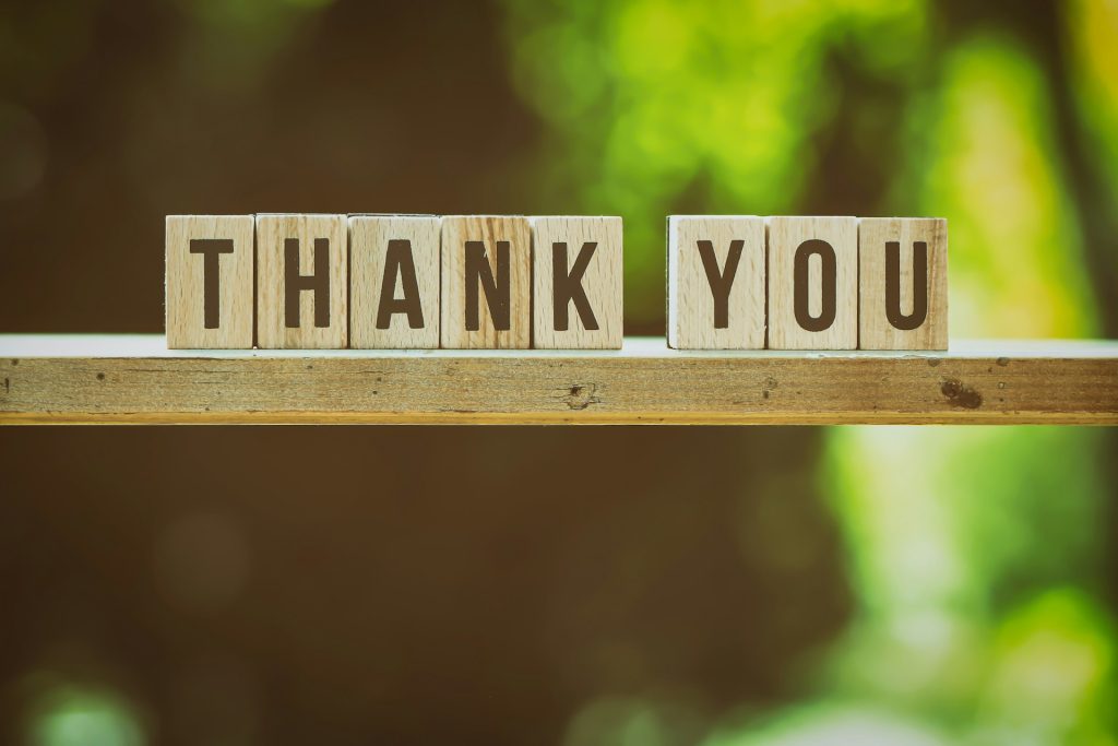 Wooden tiles spelling out the words thank you.