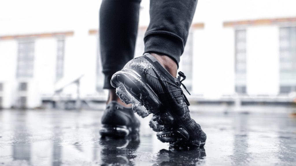 A person's feat wearing cool trainers or sneakers that look like they are ready for a workout.