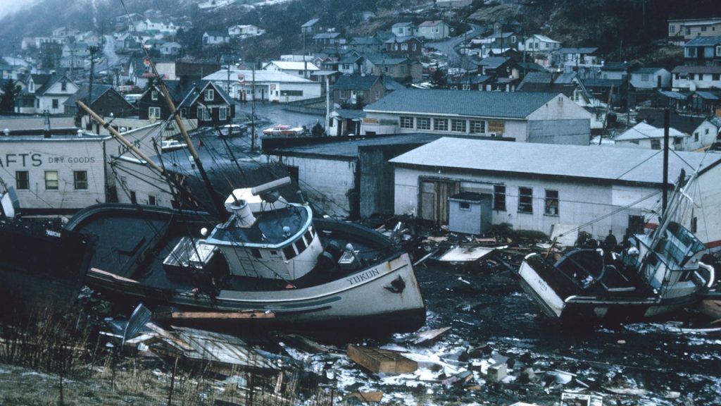 Fishing boats on their side, stranded on high ground, with rubbish and debris scattered all around.