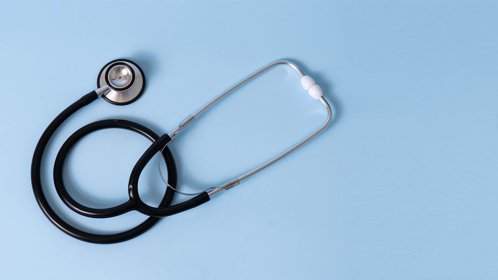 A stethoscope lying on a table top.