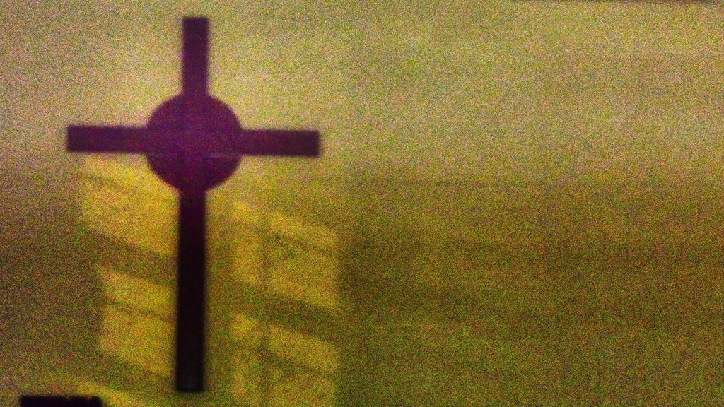 A stylised cross on a wall.