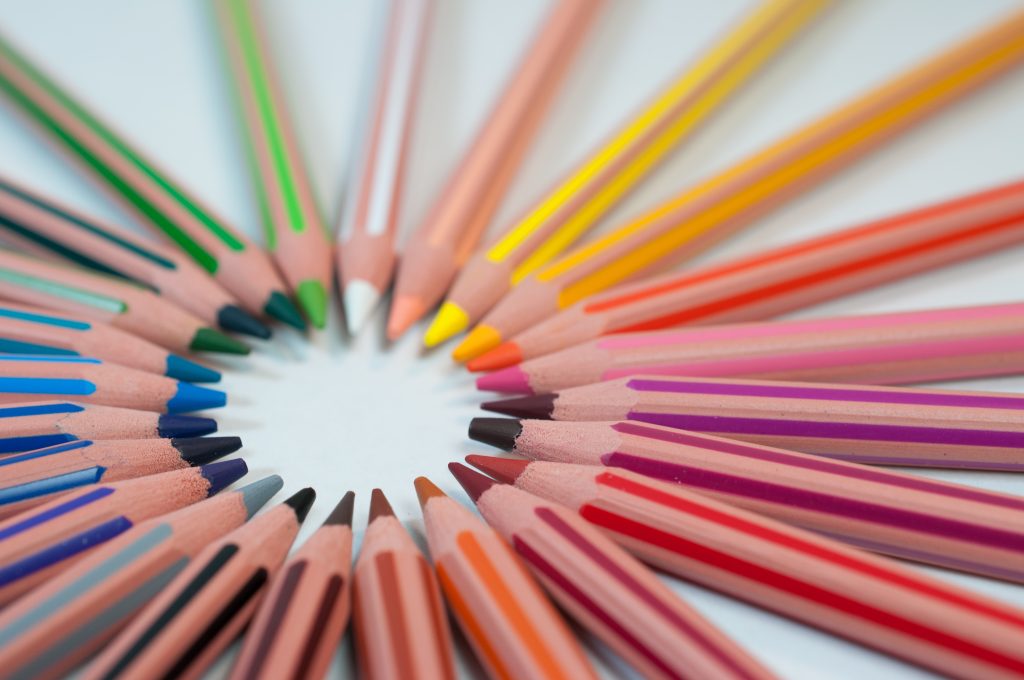 Tips of coloured pencils arranged in a circle.