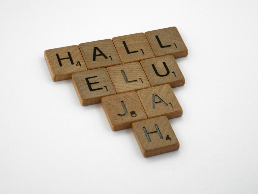 Wooden Scrabble tiles spelling out the word hallelujah.