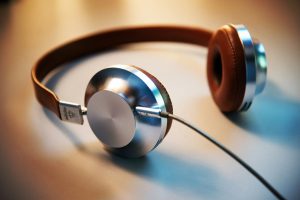 A pair of headphones lying on a desk.