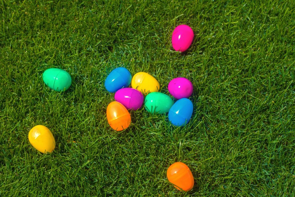 Plastic easter eggs lying on grass.