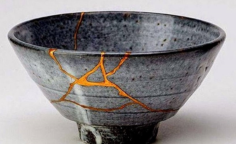 A cracked bowl that has been repaired with gold.