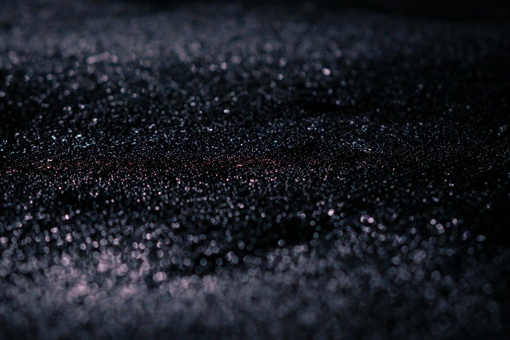 A closeup of grit on asphalt.