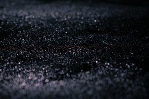 A closeup of grit on asphalt.