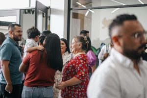 A church family gather in a hall after worship and it is wonderfully diverse.