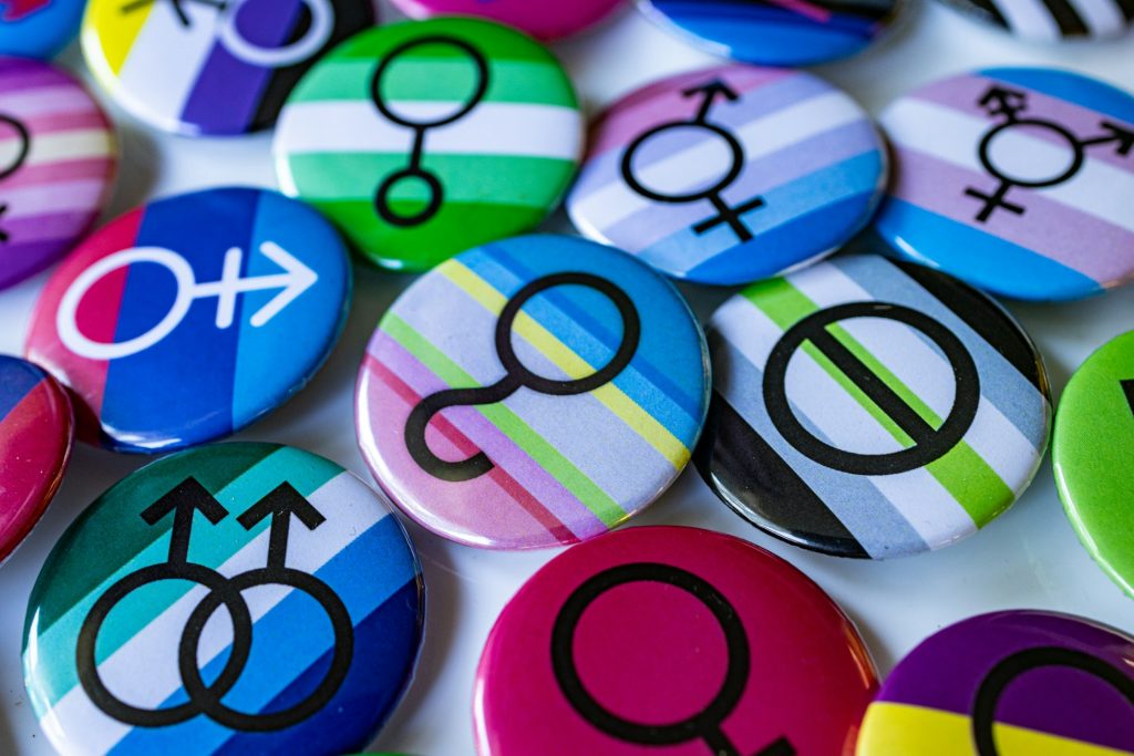A whole bunch of multicoloured badges with different symbols on them.