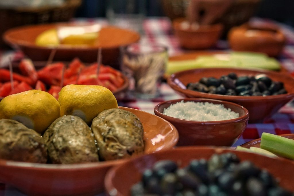 How do we live the future in the present? A table laden with bowls of colourful Mediterranean food.